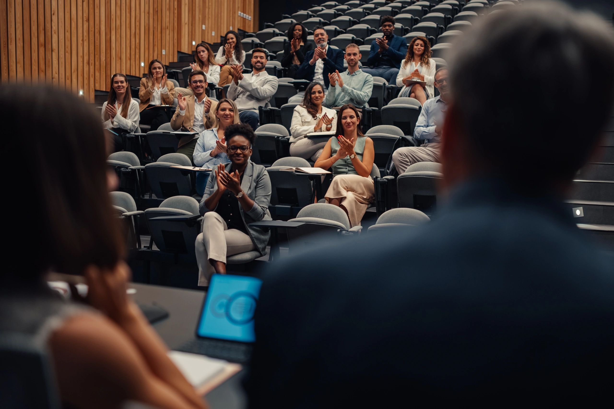 Speaker addressing an audience at a conference.